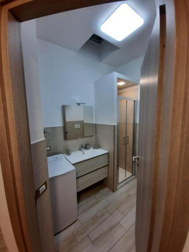 a bathroom with a white sink and a mirror at GUEST HOME in Casamicciola Terme