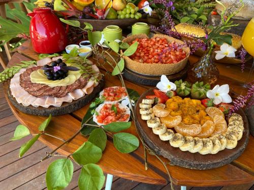 a table with many different types of food on it at Carapitangui Pousada in Barra Grande