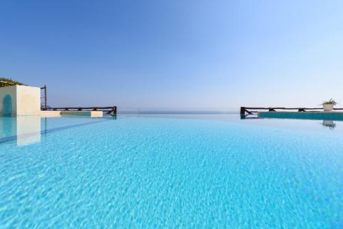 una grande piscina con acqua blu in un edificio di Pagliarulo Complex by AMALFIVACATION a Ravello