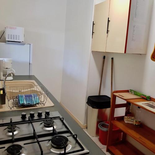 a kitchen with a stove top oven in a kitchen at La plage de Petit-Havre in Le Gosier