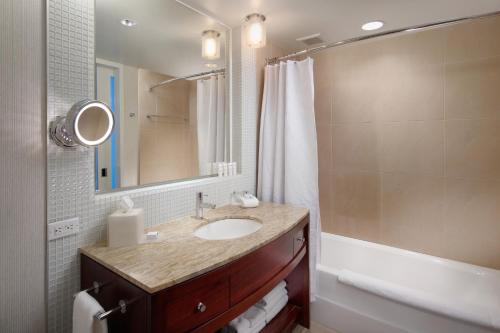 a bathroom with a sink and a mirror and a tub at InterContinental San Francisco by IHG in San Francisco