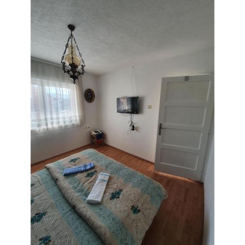 a bedroom with a bed with a rug and a door at Caričin konak in Peta