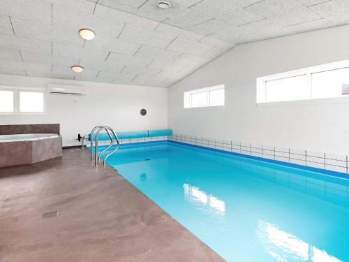 a swimming pool with blue water in a room at 14 person holiday home in V ggerl se in Marielyst