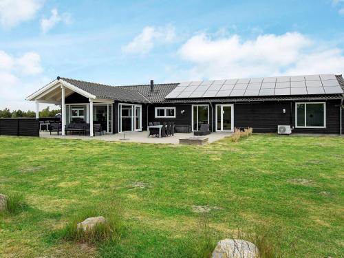 a house with a solar roof on a yard at 14 person holiday home in V ggerl se in Marielyst