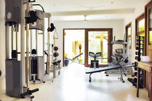 a gym with treadmills and machines in a room at UXUA Casa Hotel & Spa in Trancoso