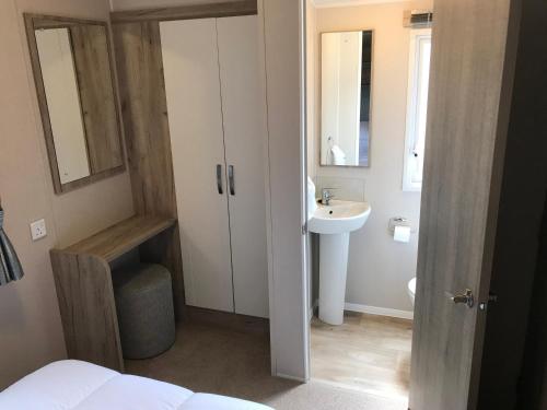 a small bathroom with a sink and a toilet at Luxury 3 Bedroom Caravan MC37, Shanklin, Isle of Wight in Shanklin