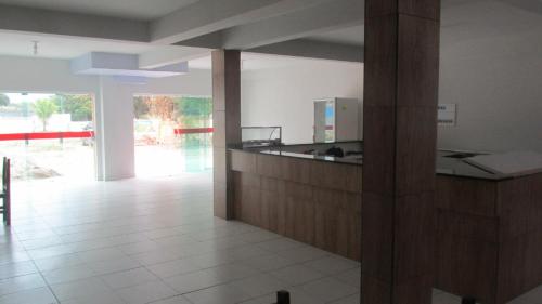 a kitchen with a counter top in a room at Pousada Alto Mar in Matinhos