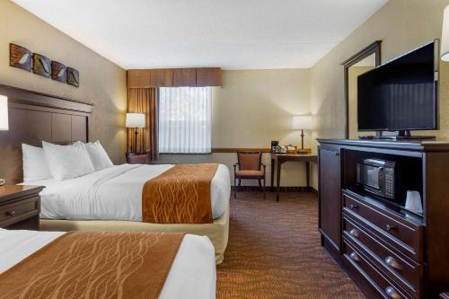 a hotel room with two beds and a flat screen tv at Comfort Inn at Thousand Hills in Branson