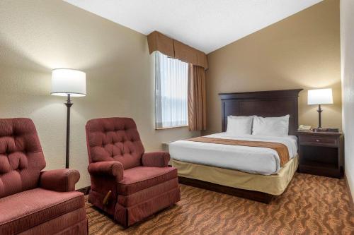 a hotel room with a bed and a chair at Comfort Inn at Thousand Hills in Branson