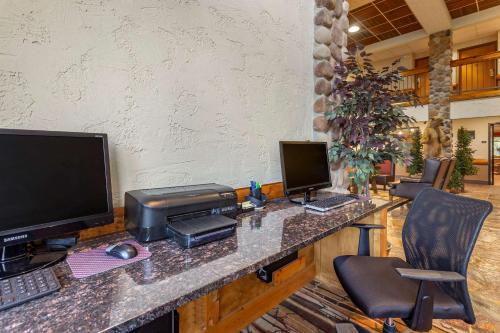 an office with a desk with two computer monitors and a printer at Comfort Inn & Suites Branson Meadows in Branson