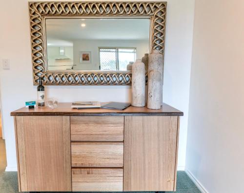 a mirror sitting on top of a wooden dresser at Peace Rise, Denmark in Denmark