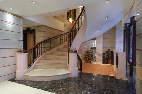a staircase in a home with a marble floor at K Hotel Keelung in Keelung