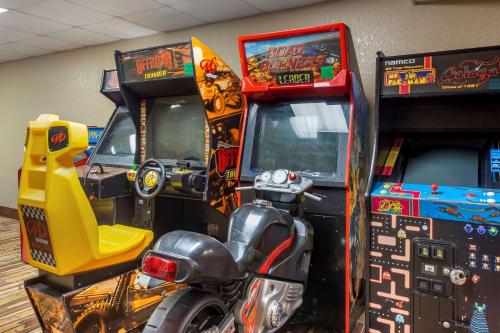 a room with two video game machines and a motorcycle at Comfort Inn & Suites Branson Meadows in Branson