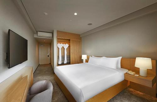 Säng eller sängar i ett rum på ANSA Okinawa Resort