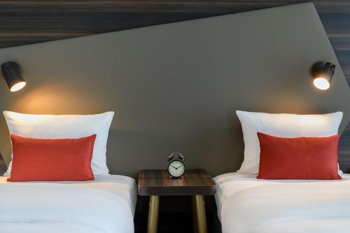 Un ou plusieurs lits dans un hébergement de l'établissement Aparthotel Adagio Bremen City
