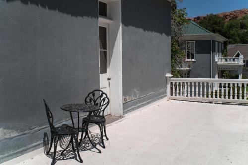 two chairs and a table on a patio at The Mulberry Inn -An Historic Bed and Breakfast in St. George