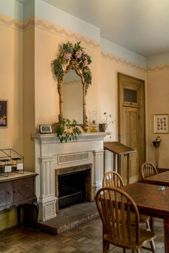 a living room with a fireplace and a mirror at The Mulberry Inn -An Historic Bed and Breakfast in St. George
