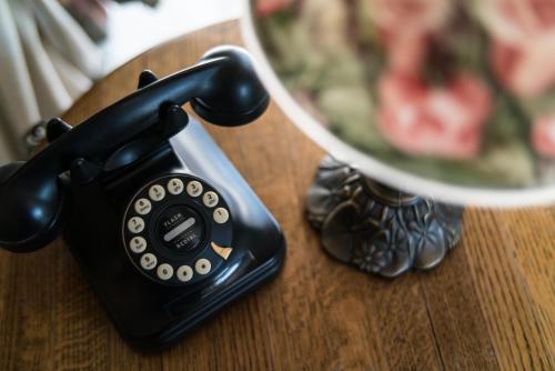 a black phone sitting on a table next to a bowl at The Mulberry Inn -An Historic Bed and Breakfast in St. George