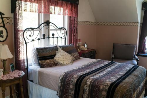 a bedroom with a bed and a window at The Mulberry Inn -An Historic Bed and Breakfast in St. George