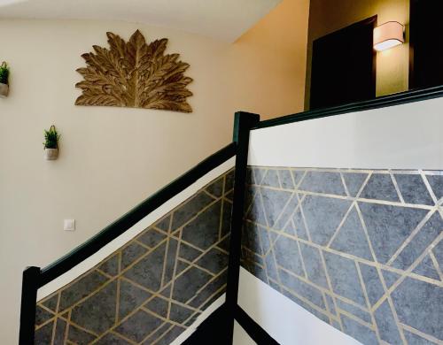 a stairway with a tile wall and a picture on the wall at Sublime vue, standing, spacieux, atypique in Muret
