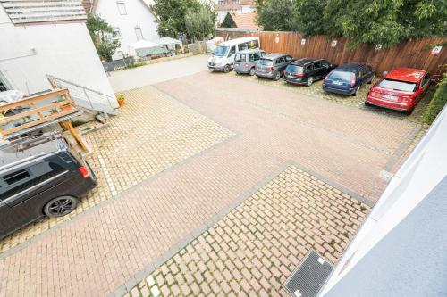 a parking lot with cars parked next to a fence at My Airport Hotel STUTTGART-AIRPORT-MESSE in Leinfelden-Echterdingen