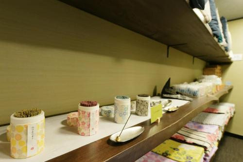 a row of cups on a shelf in a store at Hanasuishou in Fuefuki