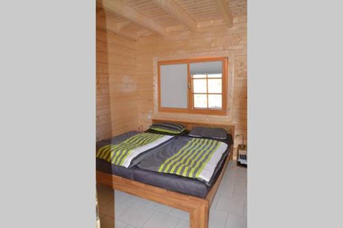 Ένα ή περισσότερα κρεβάτια σε δωμάτιο στο Ferienhaus am See in Fleeth