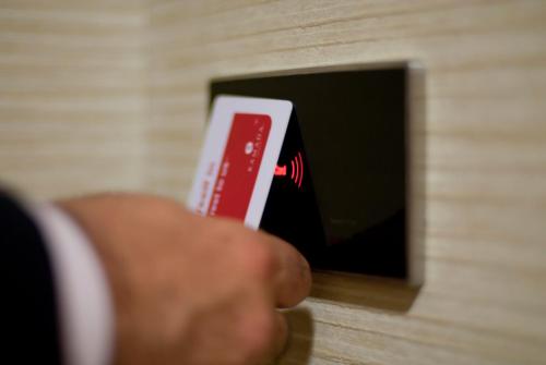 a person holding a nintendo wii game controller at Ramada by Wyndham Oradea in Oradea