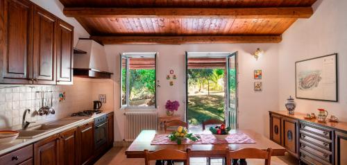 a kitchen with a table and some chairs in it at Agriturismo Borgo degli ulivi in Canicattini Bagni