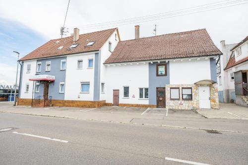 two white houses on the side of a street at My Pension STUTTGART-AIRPORT-MESSE in Leinfelden-Echterdingen
