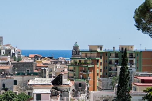 a city with buildings and the ocean in the background at Valle d'Amalfi Suites in Amalfi