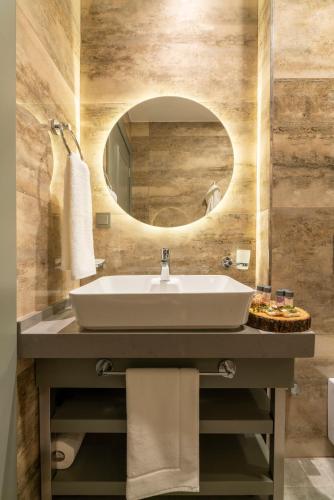 a bathroom with a sink and a mirror at SUNOLUS VINEYARDHOUSe in Kayseri