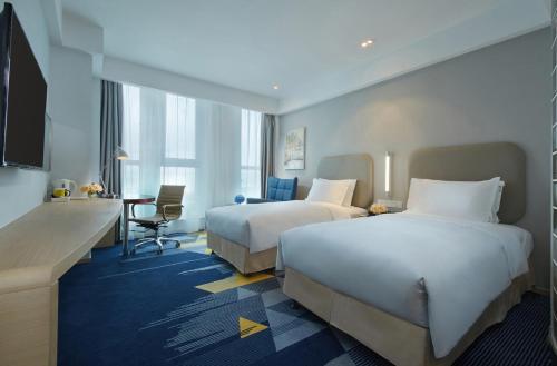 Ένα ή περισσότερα κρεβάτια σε δωμάτιο στο Holiday Inn Express - Qingdao West Coast by IHG