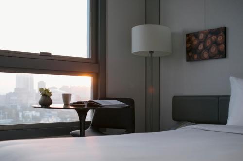 a hotel room with a bed and a lamp at Hotel Stage in Hong Kong