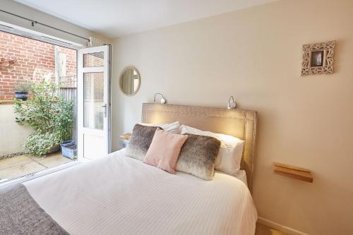 a bedroom with a bed with white sheets and pillows at Host & Stay - The Eskape in Whitby