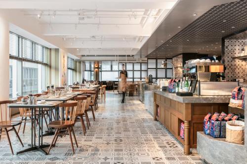 a restaurant with a row of tables and chairs at Hotel Stage in Hong Kong