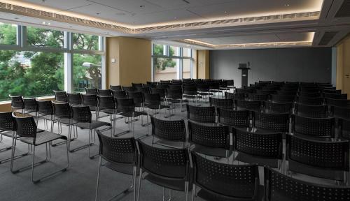 an empty room with chairs and a cross on the wall at Hotel Stage in Hong Kong