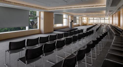 a lecture hall with chairs and a podium in the middle at Hotel Stage in Hong Kong