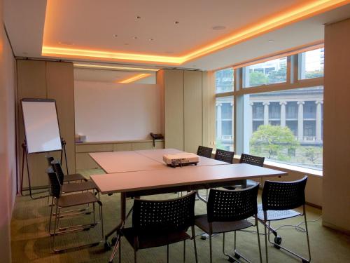 a meeting room with a table and chairs at Hotel Stage in Hong Kong