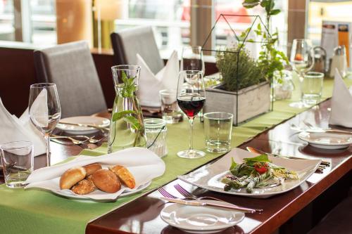 a table with plates of food and glasses of wine at Hotel Restaurant Winkler in Mürzzuschlag