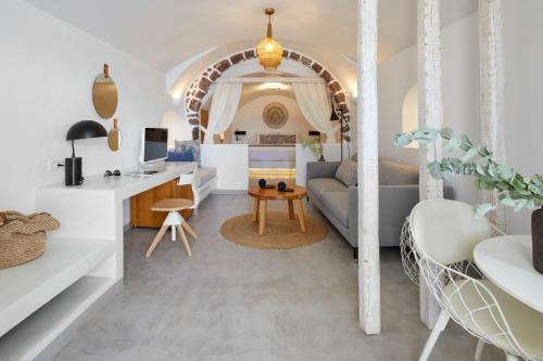 a living room with a couch and a table at Filotera Suites in Oia