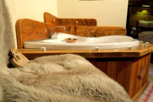 a bathroom with a sink and a white tub at Romantica suite con vasca idromassaggio in Aosta
