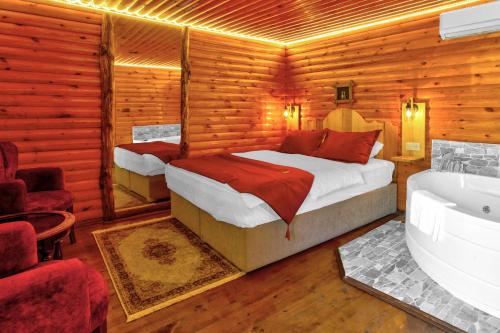 a bedroom with a bed and a tub in a room at Paradise Plus Ağva in Agva