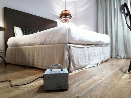 a suitcase sitting on the floor in front of a bed at Hotel Cuéntame La Puebla in Burgos