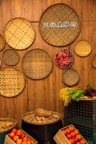 a bunch of baskets on a wall with fruits and vegetables at Arsma Hotel in Hualien City