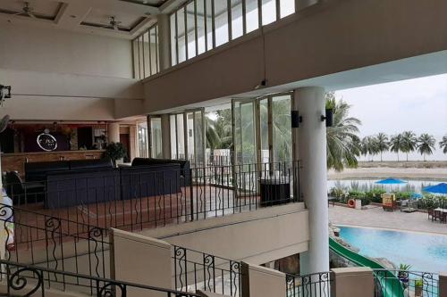 a large building with a pool and a living room at Port Dickson PD Beach Front Homestay in Port Dickson