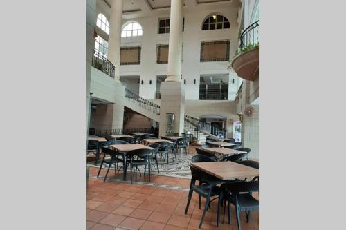 an empty restaurant with tables and chairs in a building at Port Dickson PD Beach Front Homestay in Port Dickson