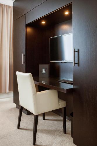 a white chair sitting at a desk with a computer at Elite Park Avenue Hotel in Gothenburg