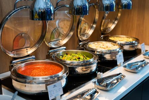 a buffet of different types of food on a table at Holiday Inn Express Shanghai Tangzhen by IHG - 20 mins to PVG Airport and Disney land in Shanghai