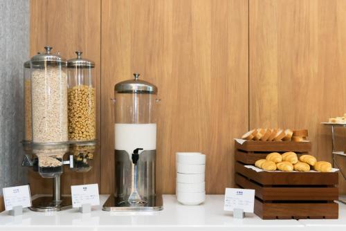 a counter with a blender and a box of bread at Holiday Inn Express Shanghai Tangzhen by IHG - 20 mins to PVG Airport and Disney land in Shanghai